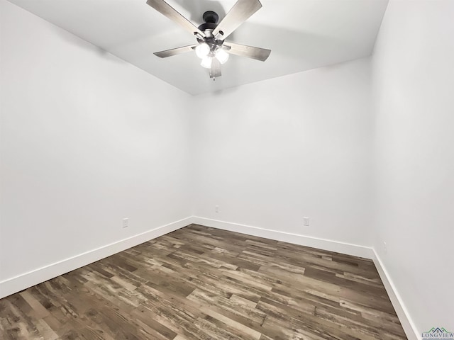 spare room featuring dark wood-type flooring and ceiling fan