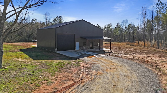 view of outdoor structure with a garage and covered porch