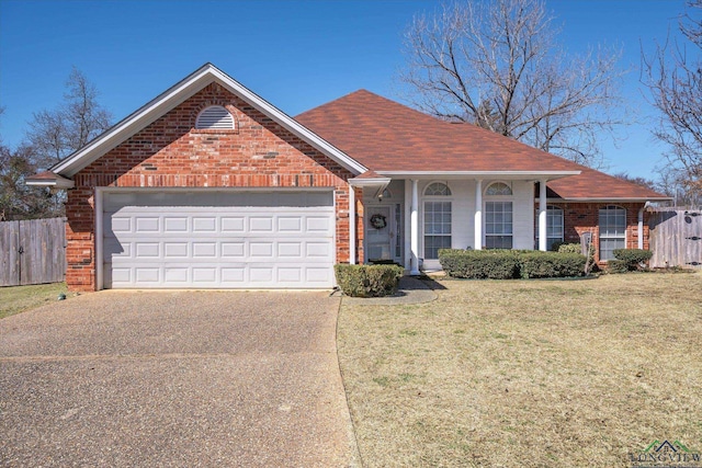 ranch-style home featuring a front yard, brick siding, driveway, and fence