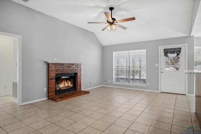 unfurnished living room with lofted ceiling, light tile patterned floors, visible vents, a ceiling fan, and a brick fireplace