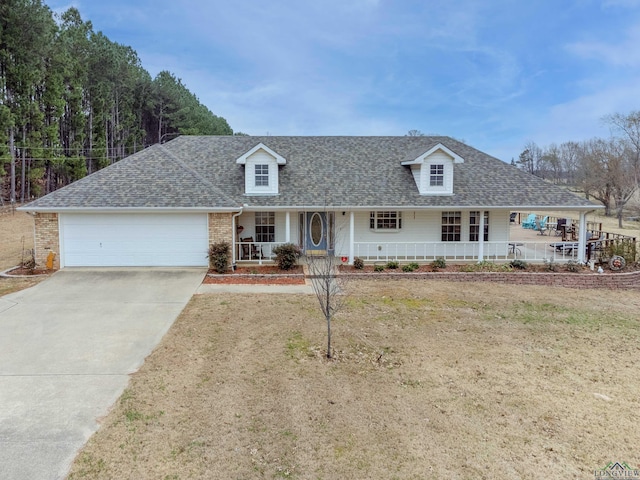 view of front of house featuring a garage, a front lawn, and a porch