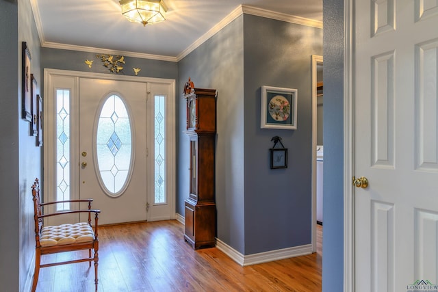 foyer featuring ornamental molding, plenty of natural light, and light wood-type flooring