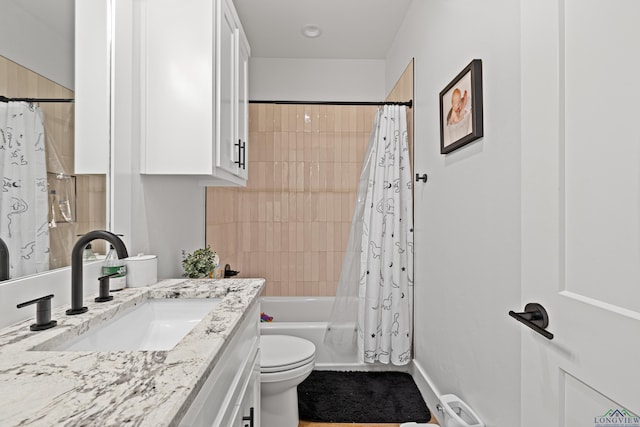 full bathroom featuring vanity, shower / tub combo, and toilet