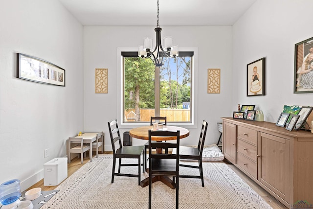 dining space featuring a chandelier and light wood-type flooring