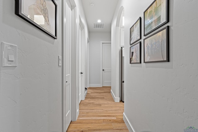 hallway with light hardwood / wood-style flooring