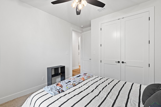 bedroom with carpet, a closet, and ceiling fan