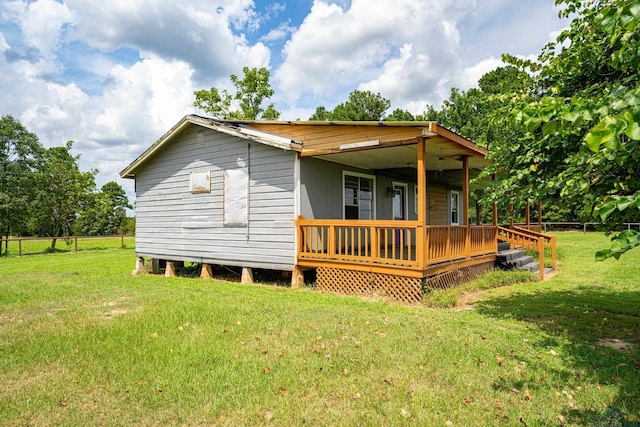 back of house with a lawn