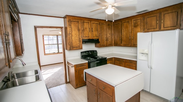 kitchen featuring ceiling fan, sink, white refrigerator with ice dispenser, electric range, and a center island