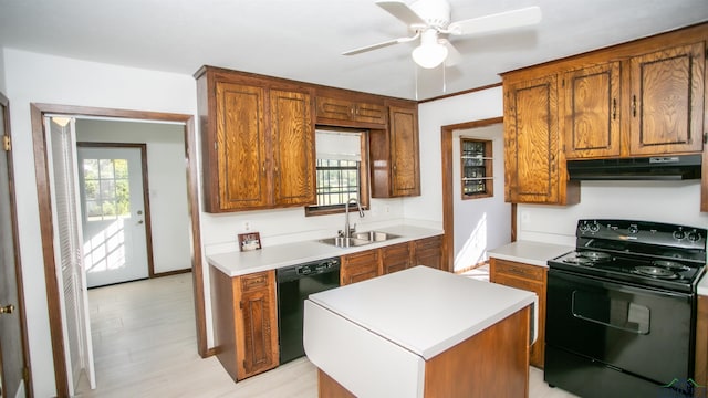 kitchen with sink, a kitchen island, ceiling fan, and black appliances