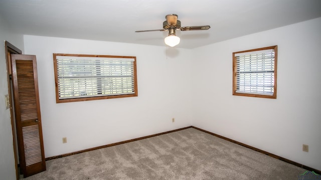 unfurnished room with ceiling fan and carpet floors