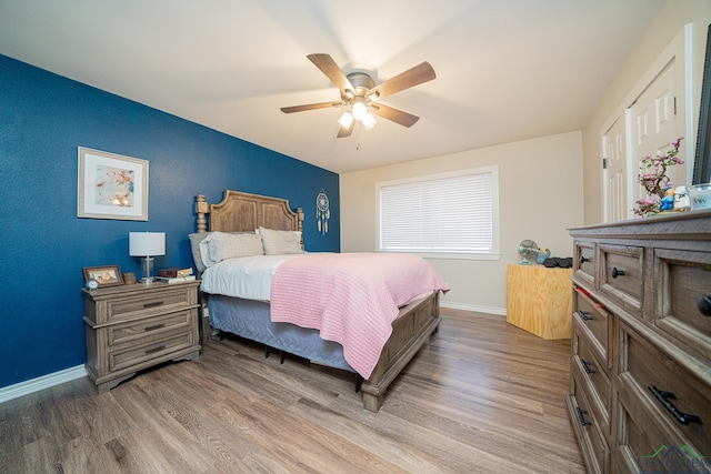 bedroom with wood-type flooring and ceiling fan