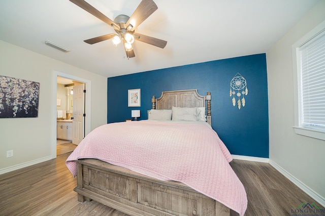 bedroom featuring ceiling fan, wood-type flooring, and ensuite bathroom