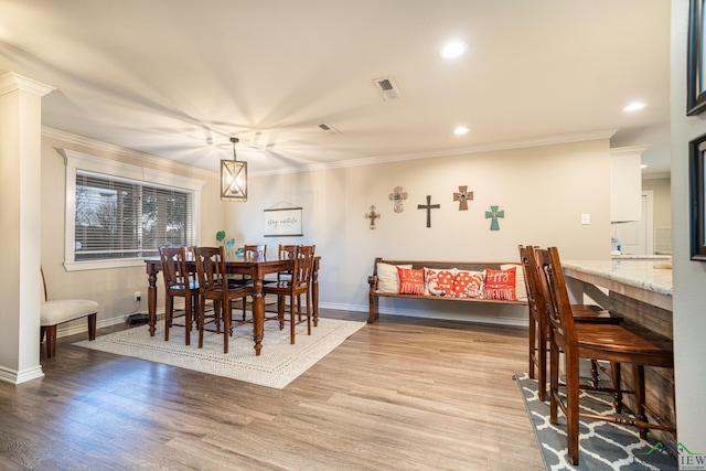 dining room featuring wood-type flooring and ornamental molding