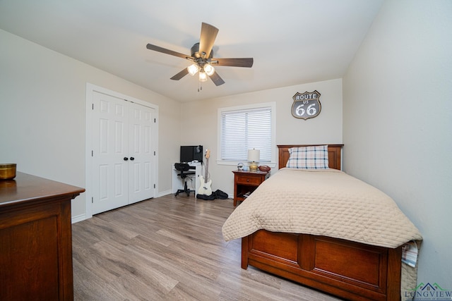 bedroom featuring ceiling fan, a closet, and light wood-type flooring