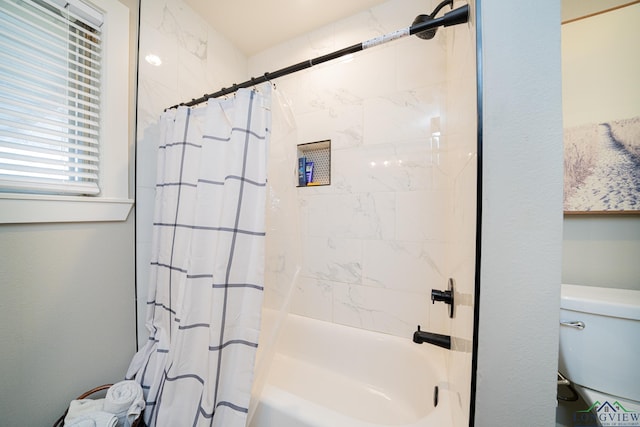 bathroom with toilet and shower / bath combo