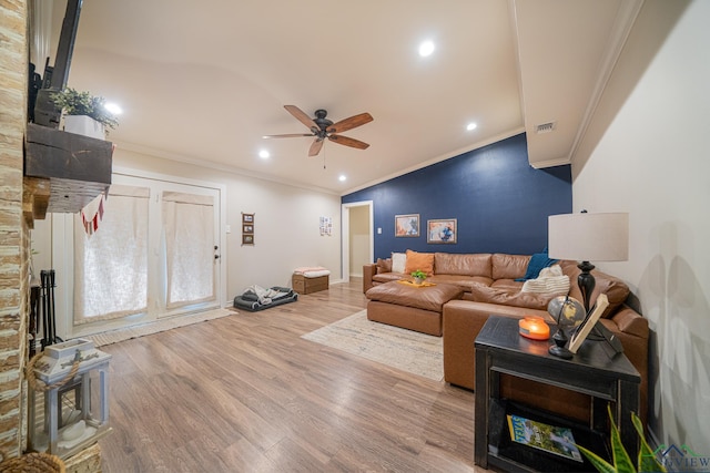 living room featuring crown molding, wood-type flooring, and ceiling fan