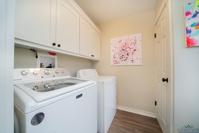 laundry room featuring cabinets, dark hardwood / wood-style flooring, and washer and dryer