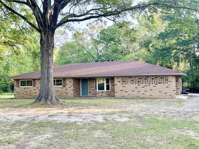single story home featuring brick siding