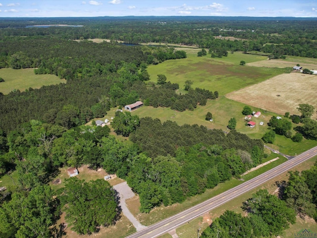 drone / aerial view featuring a wooded view