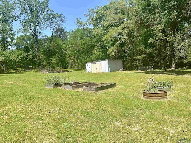 view of yard featuring an outbuilding, a garden, and a storage shed