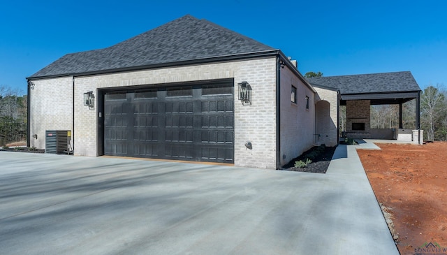 view of home's exterior with a garage and central AC