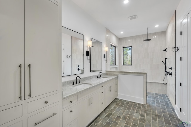 bathroom featuring vanity and a tile shower