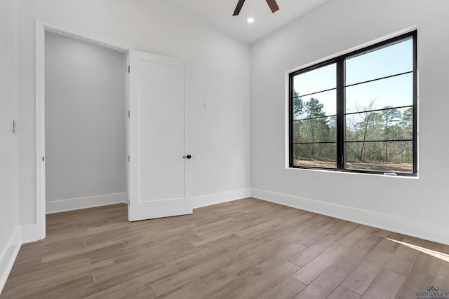 unfurnished bedroom featuring ceiling fan and light hardwood / wood-style flooring