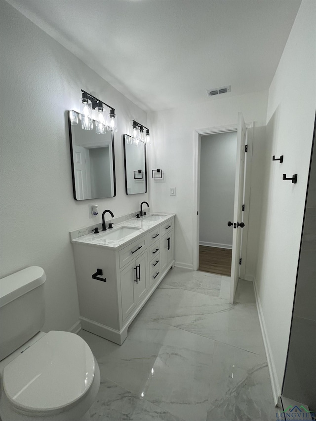 bathroom featuring toilet, a sink, visible vents, baseboards, and marble finish floor