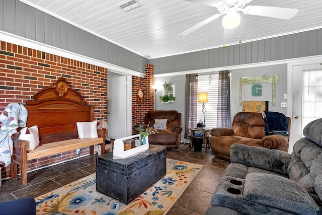 living room with wood walls and brick wall