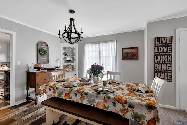 dining space featuring crown molding and a chandelier