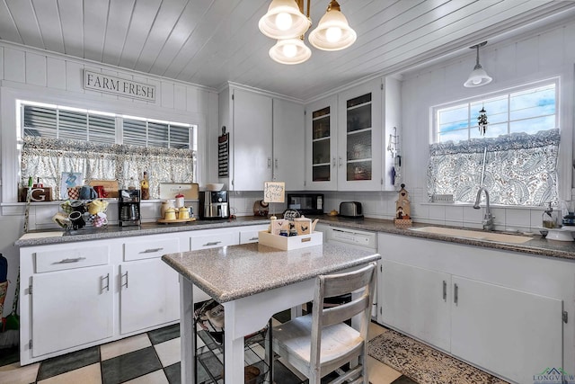 kitchen with pendant lighting, white cabinetry, sink, and wooden ceiling