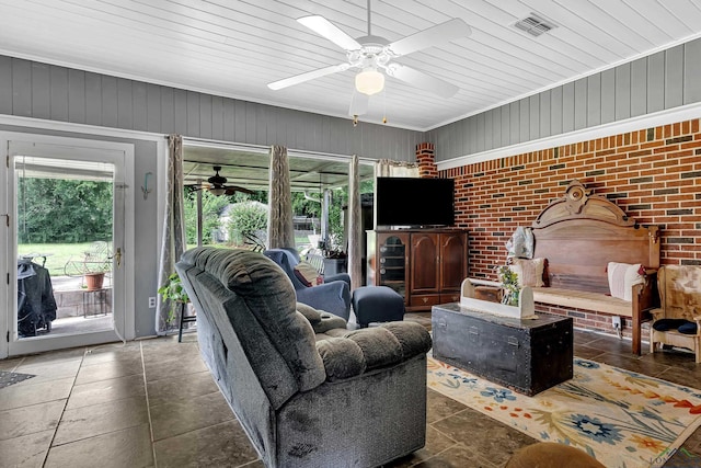 living room with wood walls and brick wall