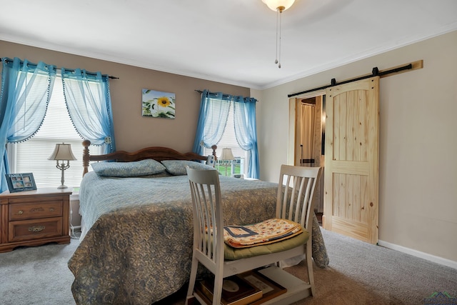 carpeted bedroom with a barn door and crown molding