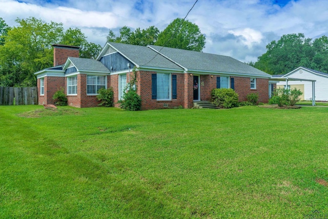 ranch-style home featuring an outbuilding, a front lawn, and a garage