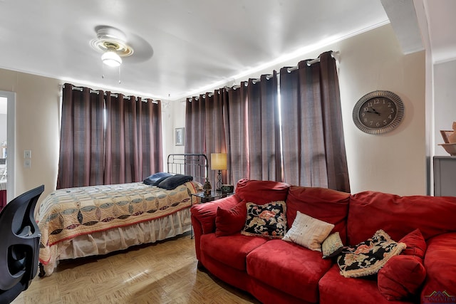 bedroom with ceiling fan and parquet floors