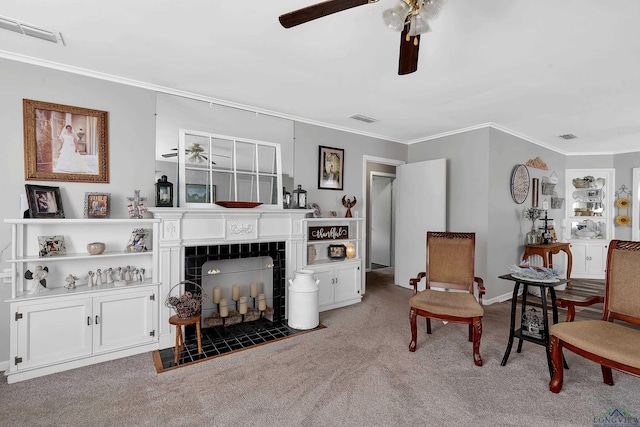 interior space with a tile fireplace, ceiling fan, and ornamental molding