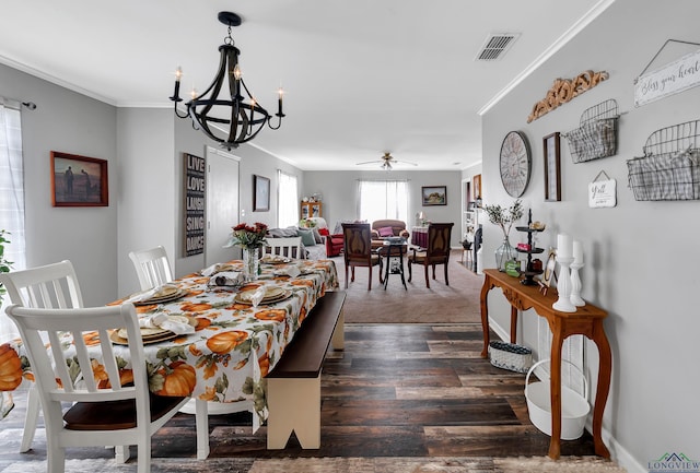 dining area with ceiling fan with notable chandelier, dark hardwood / wood-style flooring, and ornamental molding