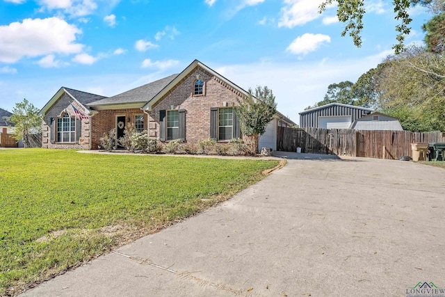 15579 County Road 1104, Flint, TX 75762 - view of front facade with brick siding, asphalt driveway, a detached garage, and roof with shingles