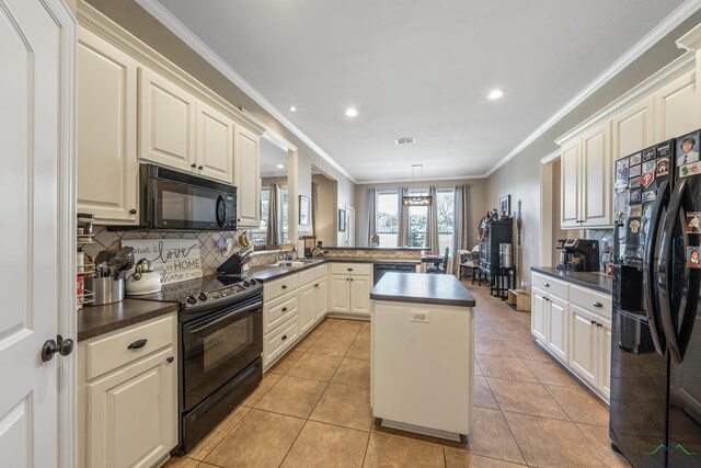 15579 County Road 1104, Flint, TX 75762 - kitchen featuring black appliances, a peninsula, dark countertops, decorative backsplash, and ornamental molding