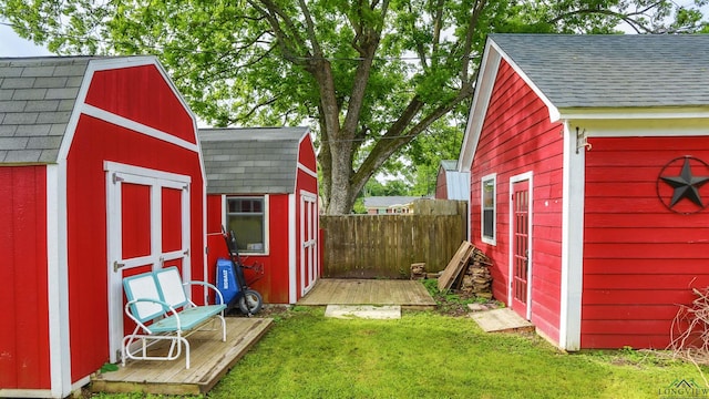 view of shed featuring fence