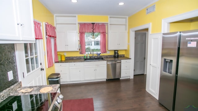 kitchen featuring white cabinets, stainless steel appliances, and a sink