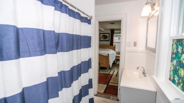 ensuite bathroom with vanity, a shower with shower curtain, and ensuite bathroom