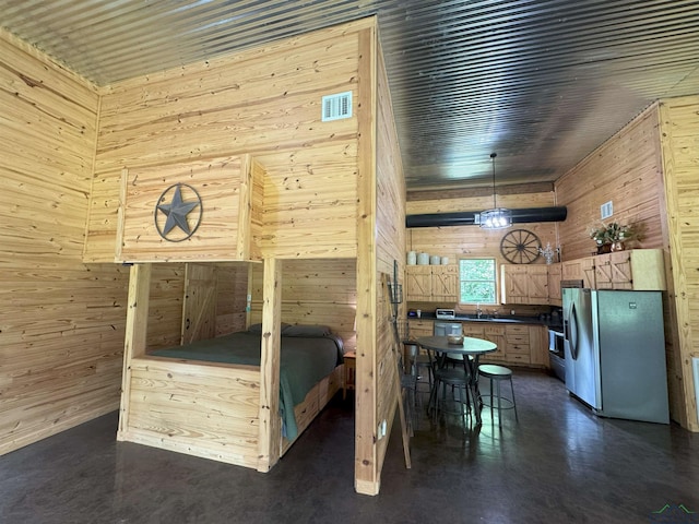 226 Almand, Waskom, TX 75692 - bedroom featuring wood walls, a sink, and stainless steel fridge