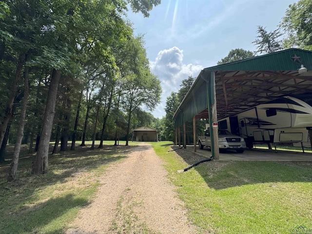 226 Almand, Waskom, TX 75692 - view of home's exterior with driveway, a carport, and a lawn