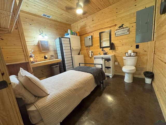 226 Almand, Waskom, TX 75692 - bedroom with electric panel, finished concrete floors, and wood walls
