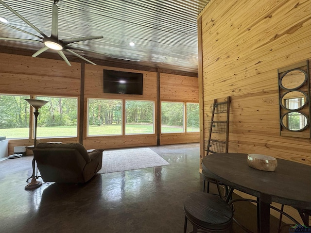 226 Almand, Waskom, TX 75692 - living room featuring concrete flooring, wooden walls, and ceiling fan