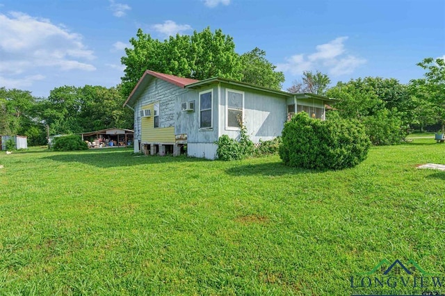 view of side of home with a yard