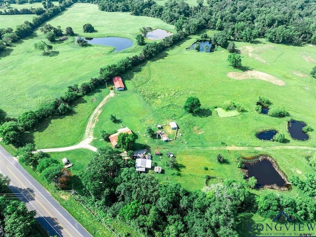 drone / aerial view featuring a water view and a rural view