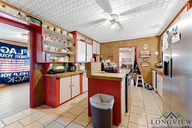 kitchen featuring ceiling fan, stainless steel appliances, and white cabinets