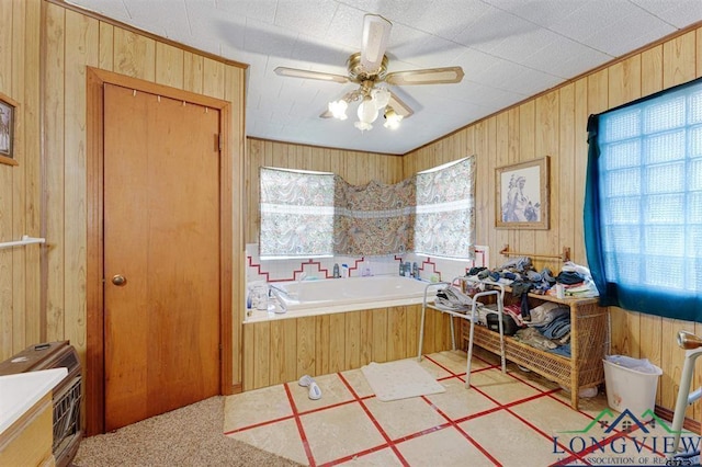 interior space with ceiling fan, wooden walls, and a bathing tub